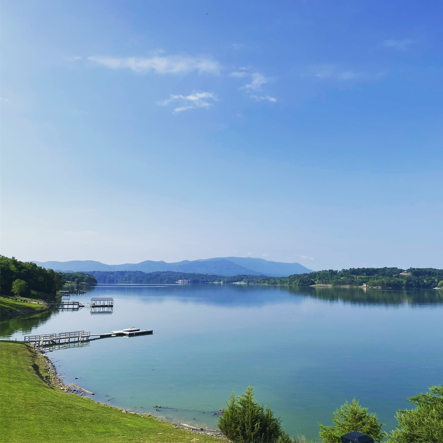 Blue Douglas Lake reflecting the sky, with the Smoky Mountains on the horizon