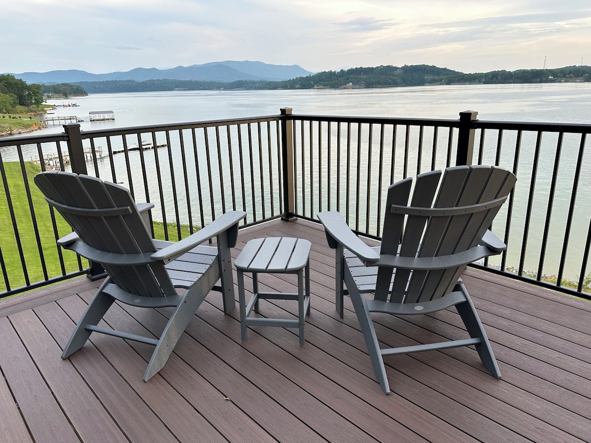 Two Adirondack chairs on the deck overlooking Douglas Lake