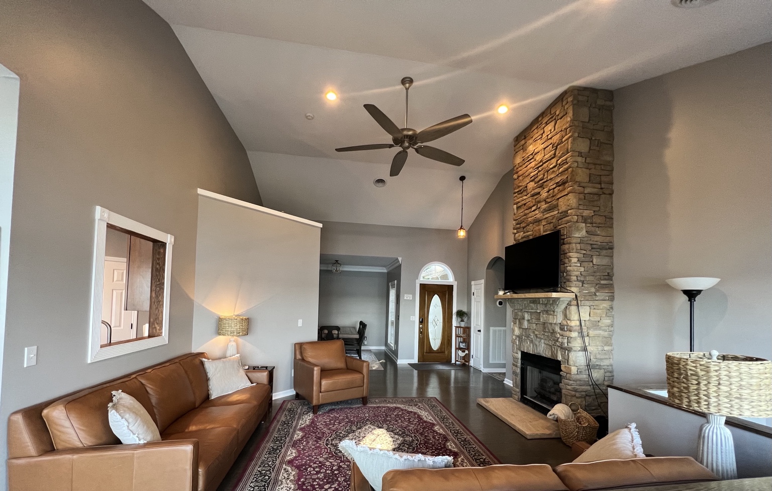 Main living room with stone fireplace and leather seating