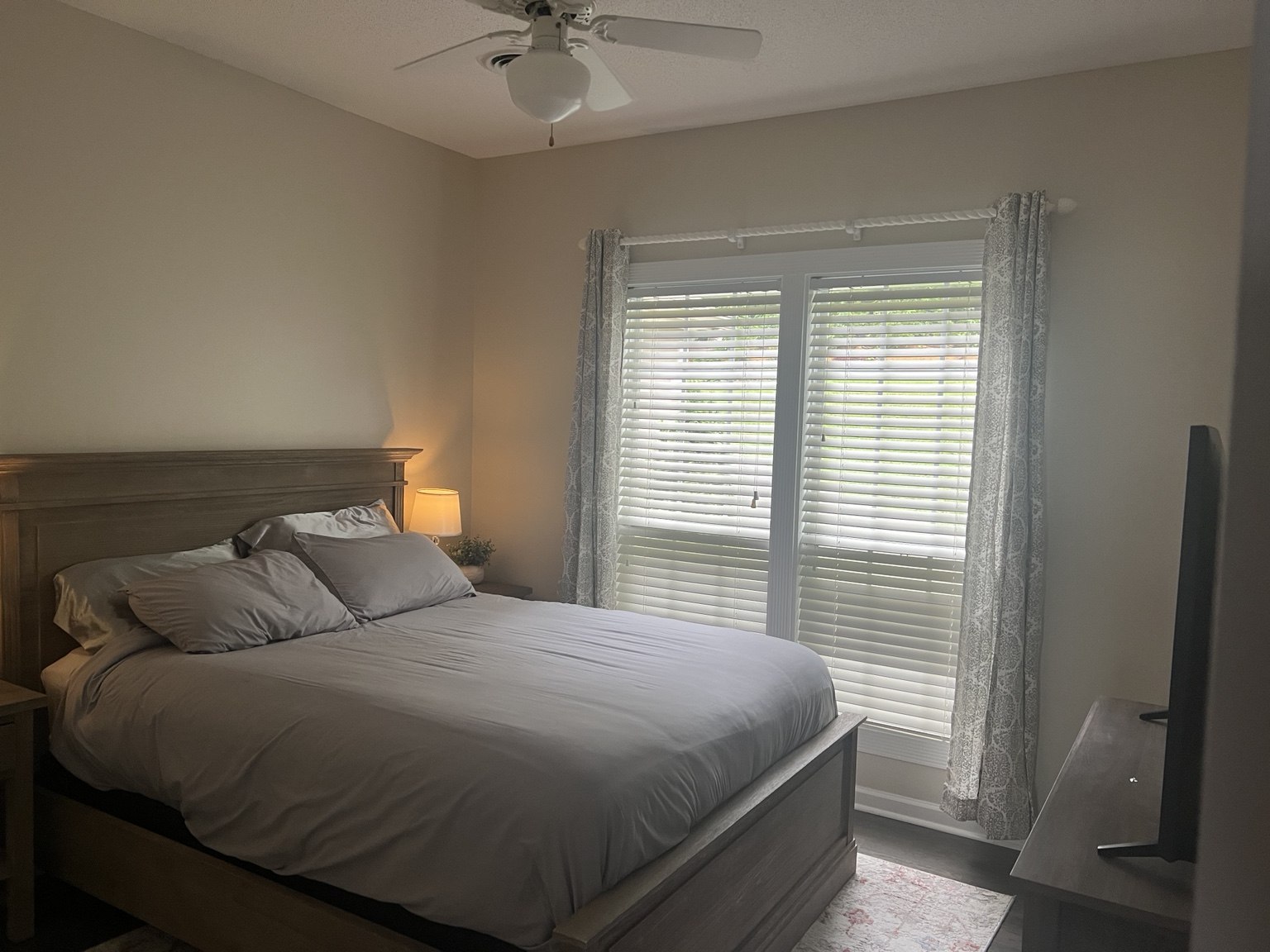 Upstairs queen bedroom with warm bedside lighting